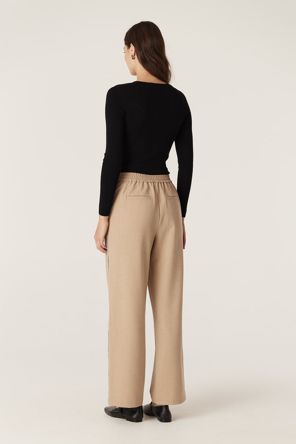 Model wearing a black Superfine Merino Gather Top with a U-neckline and subtle bust gathers.