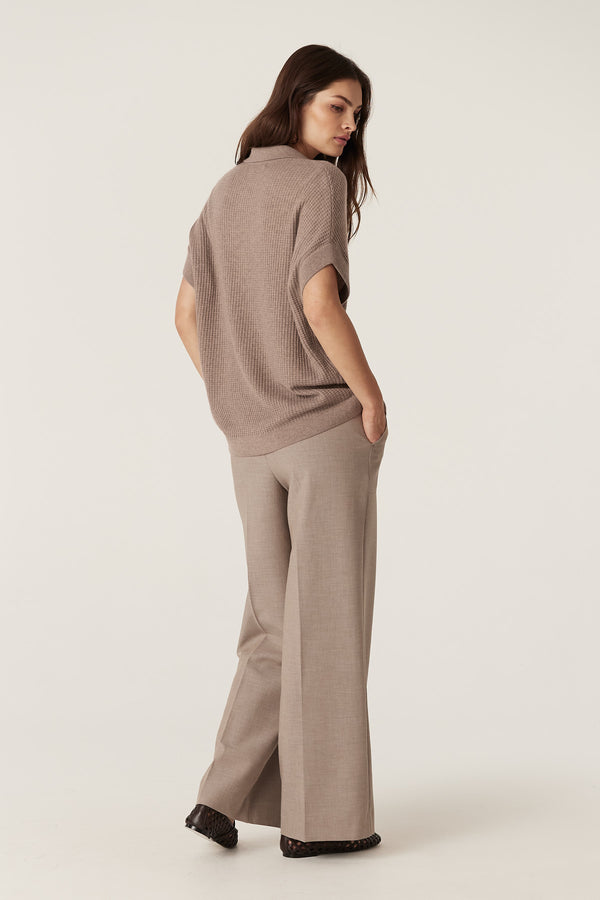 Woman in a mocha Cashwool waffle knit V-neck top with collar and relaxed fit, paired with matching trousers.