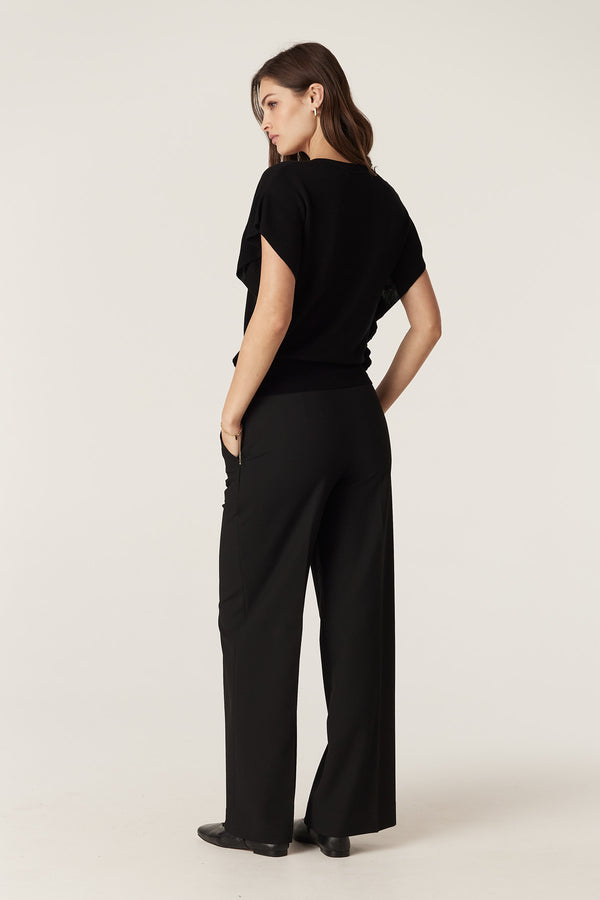 Black Silk Tencel Frill Top with V-neck, rib frill armholes, and fitted waist, worn by a model.