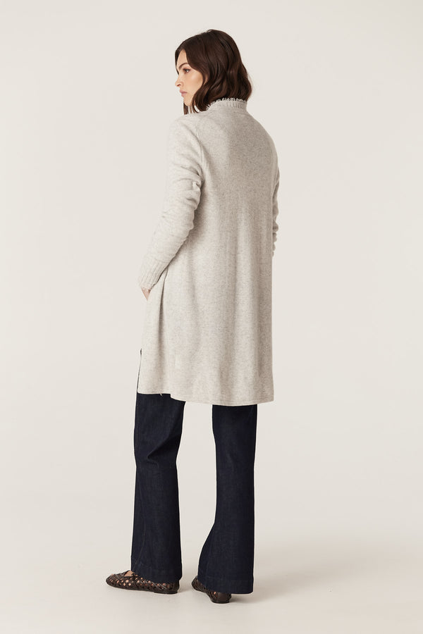 Woman in a relaxed fit Frost Cashwool Aura Cardigan with loop fringing, worn over dark jeans.