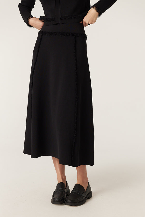 Black crepe fringe midi skirt with Milano knit texture and fringe detail on seams.