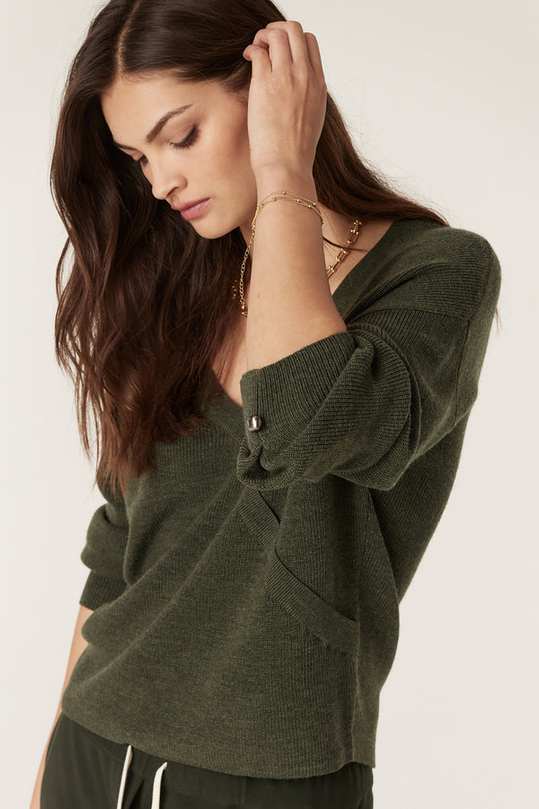 Audrey Forest Merino Jumper with V-neck, faux wrap front, and statement cuff buttons.