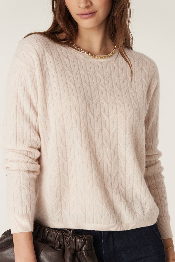 Blush Cashwool cable knit crew neck jumper with ribbed trims, worn by a model.
