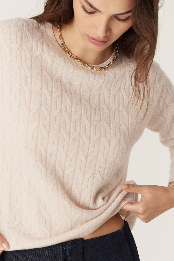 Blush Cashwool cable knit crew neck jumper with ribbed trims, worn by a model.