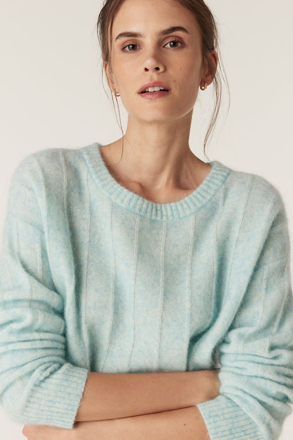Woman wearing an azure mohair blend crew neck jumper with jersey stripe stitch detailing.