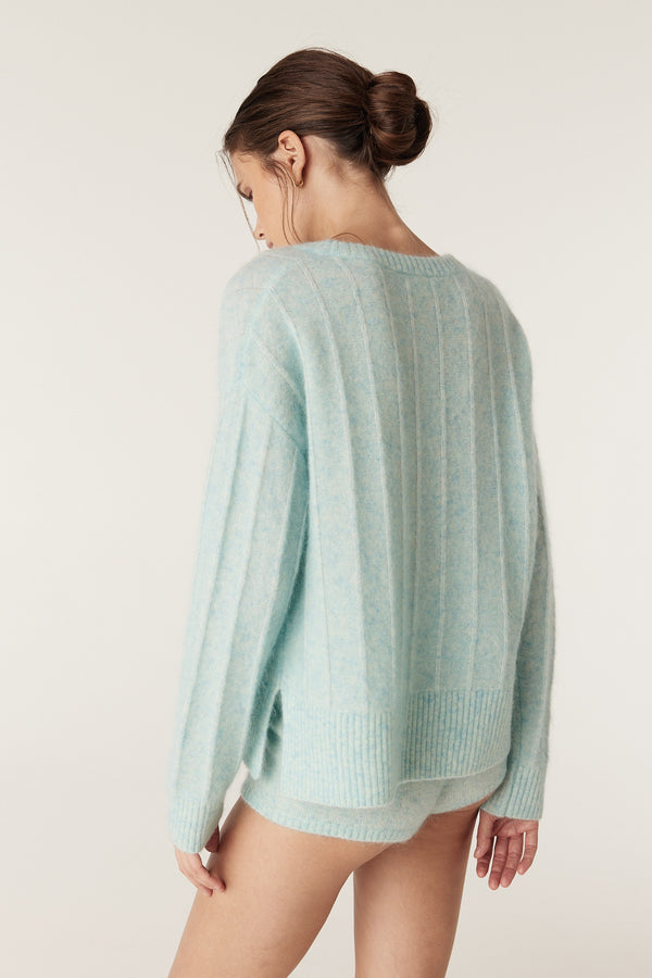 Model wearing an azure mohair blend crew neck jumper with jersey stripe stitch and ribbed trims.