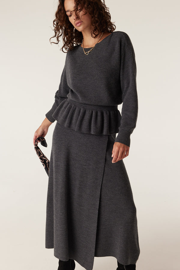 Charcoal merino wool skirt with a wrap-style front, paired with a matching peplum sweater.