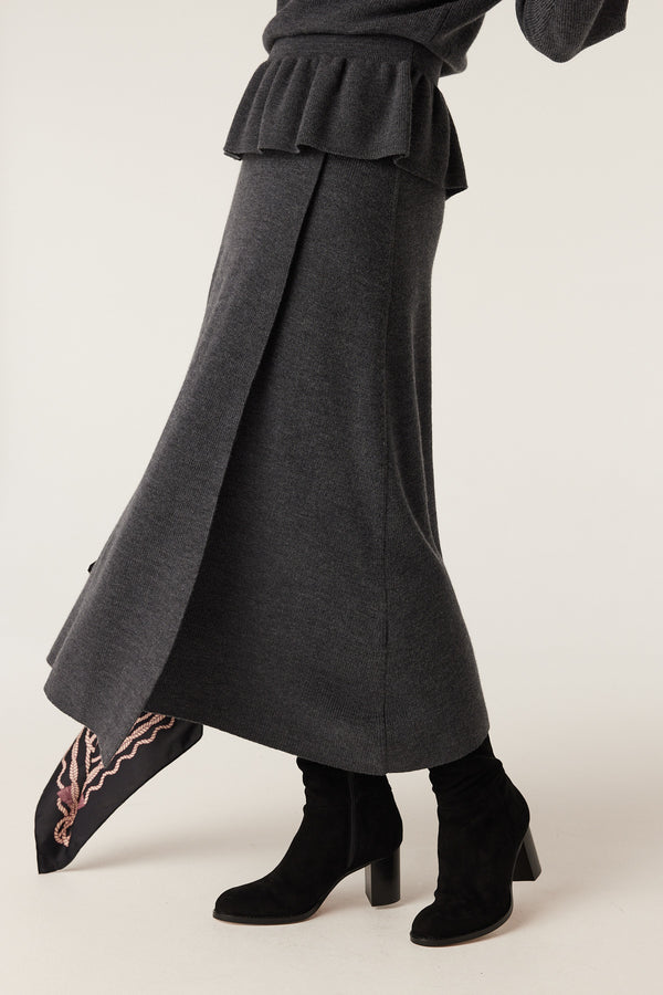 Charcoal merino wool midi skirt with a flowing A-line silhouette and front pleat detail.