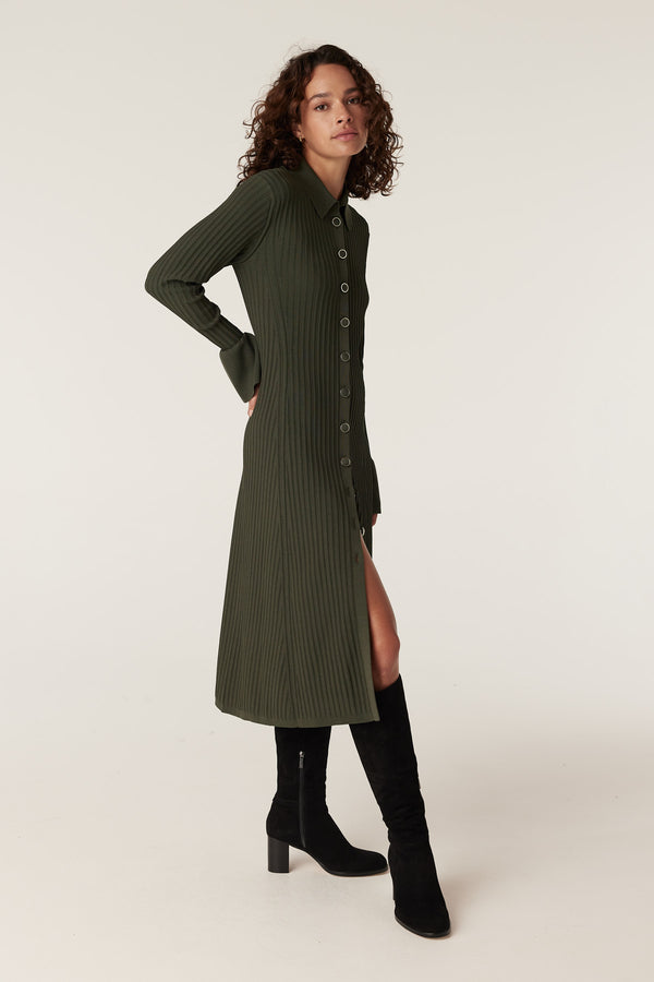 Model in a long-sleeved khaki ribbed crepe midi dress with a collar, button front, and high side slit.