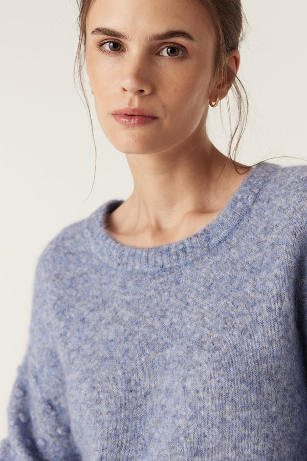 Woman wearing a denim blue mohair blend bobble jumper with a crew neck and textured knit.
