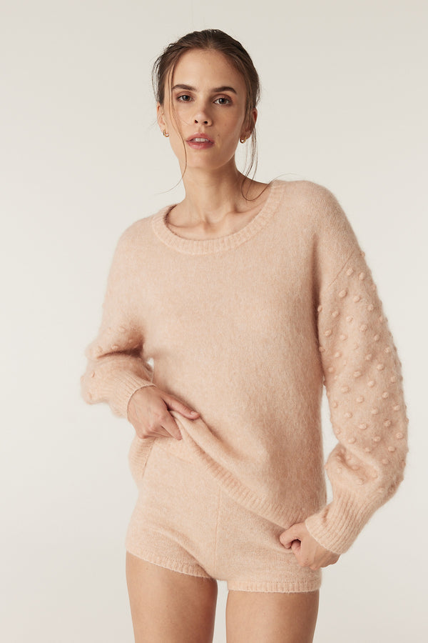 Model wearing a nude mohair blend bobble jumper with balloon sleeves and matching shorts.