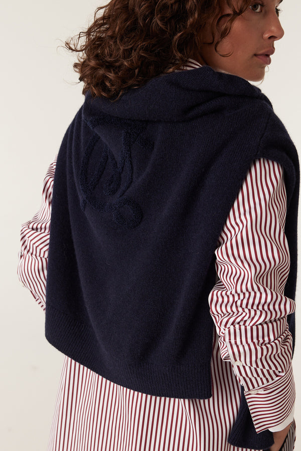 Navy Cashwool Logo Jumper worn over a striped shirt, featuring an embroidered logo on the back.