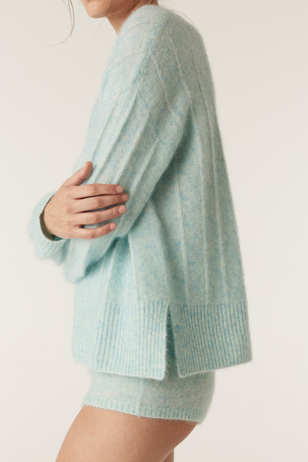 Azure mohair blend mini shorts and matching ribbed knit jumper on a model.