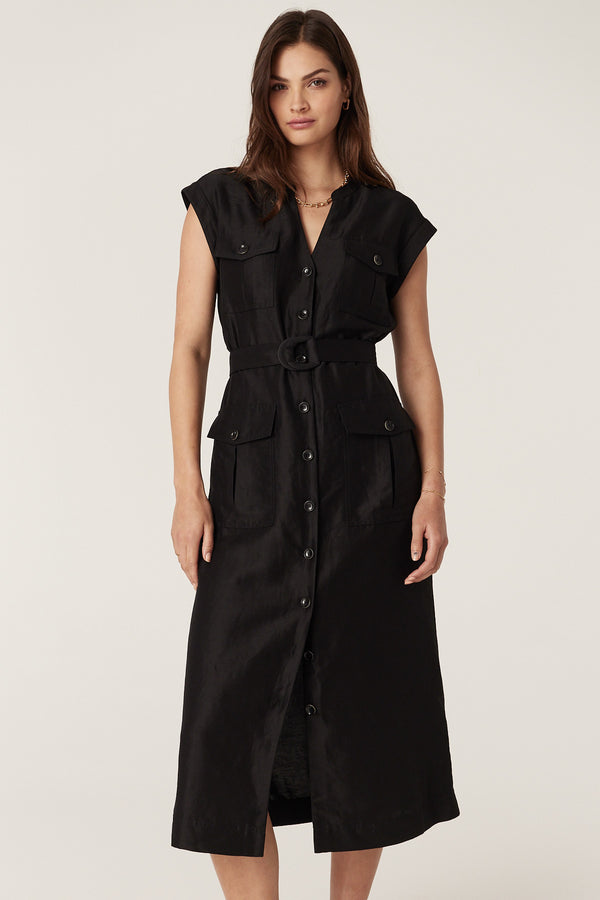 Woman in a black linen viscose Osborne dress with a button-through front, utility pockets, and D-ring belt.