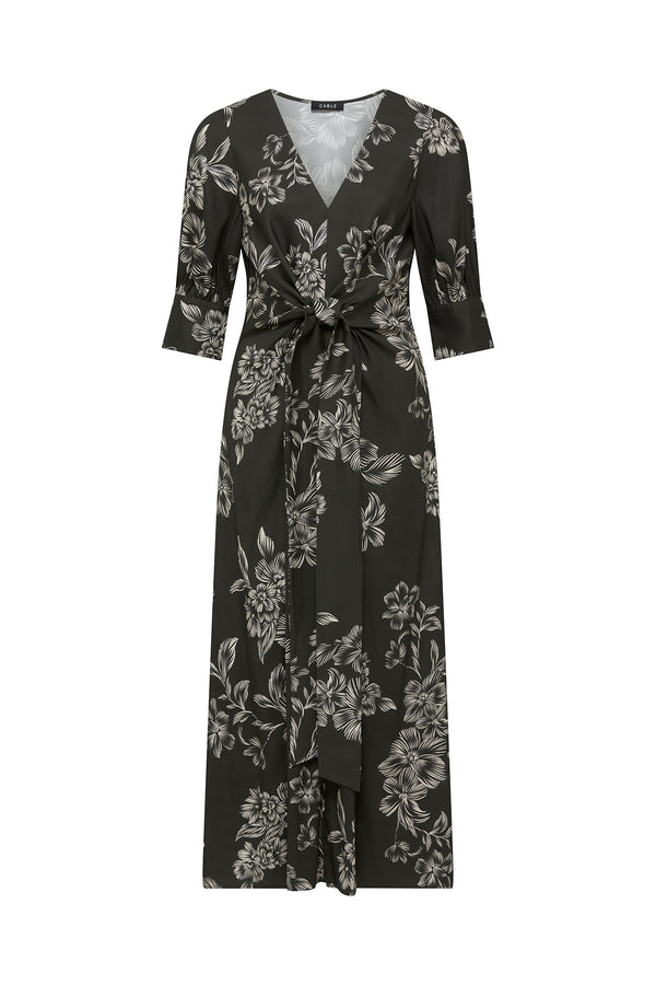 Dark green satin back viscose Holly dress with white floral print, V-neck, elbow sleeves, and wrap waist ties.