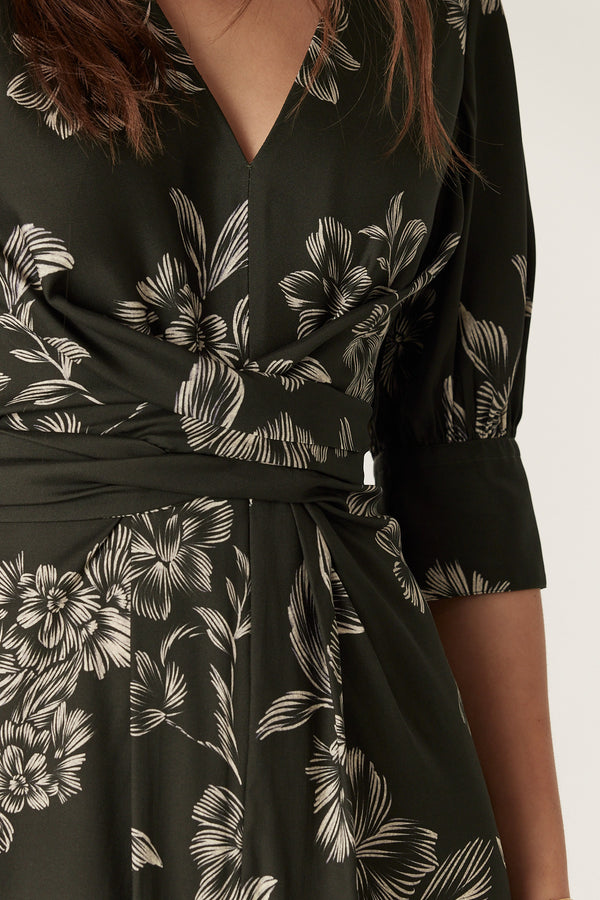 Dark green satin back viscose Holly dress with white floral print, V-neck, wrap waist, and elbow sleeves.