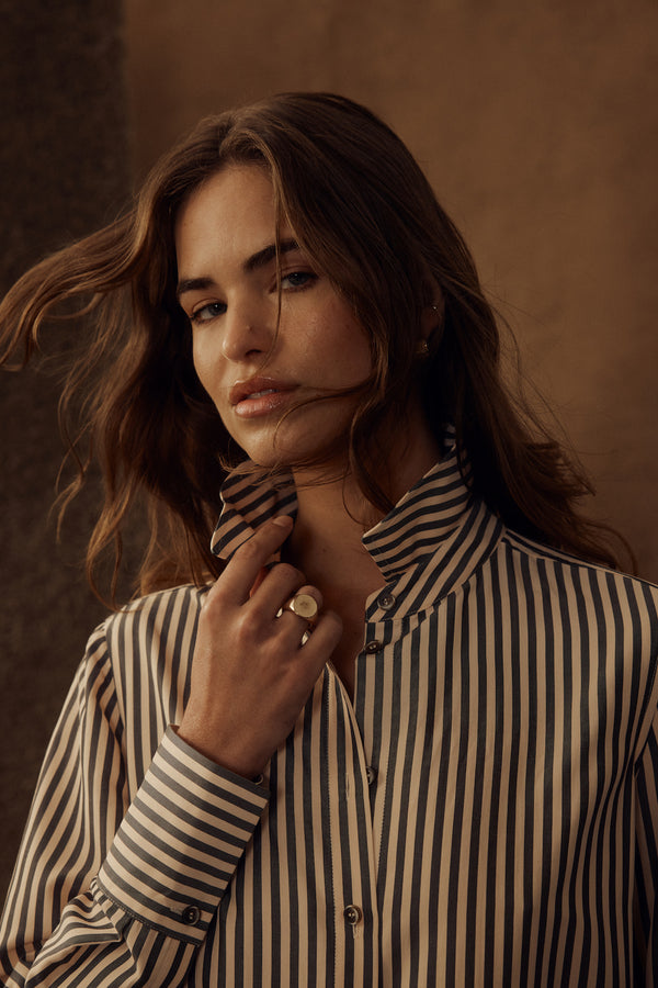 Woman wearing a Jamie Khaki Stripe Shirt with a classic collar, button front, and vertical stripes.