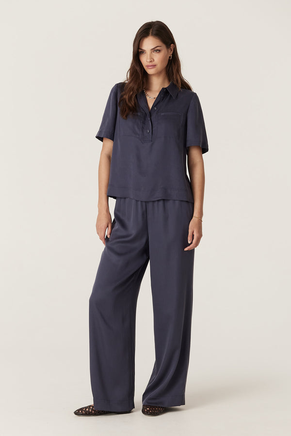 Model wears navy Lyocell Ashton Pant and matching blouse. Relaxed fit, elasticated waist, side pockets.
