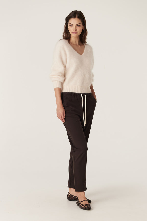 Woman in Luca Twill Jogger in Espresso, featuring a tapered leg, elasticated waist with white drawcord, and functional pockets.