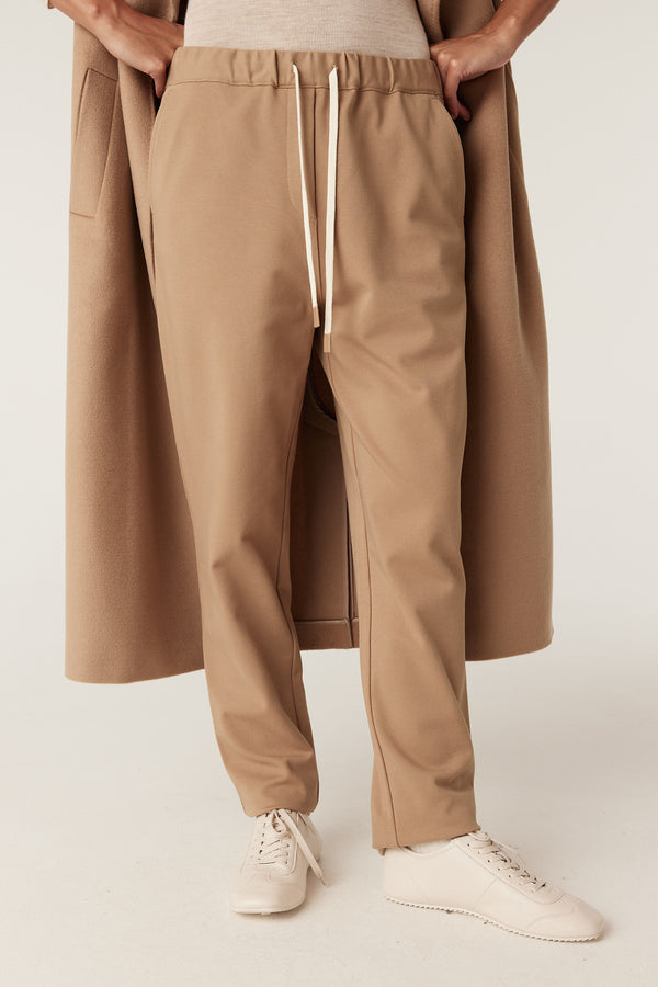 Camel Luca Twill Jogger with elastic waist, white drawstring, and side pockets, paired with a matching coat.