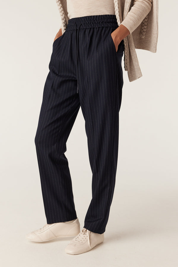 Navy pinstripe Vincent wool blend pants with elasticated waist, drawcord, and front pockets.
