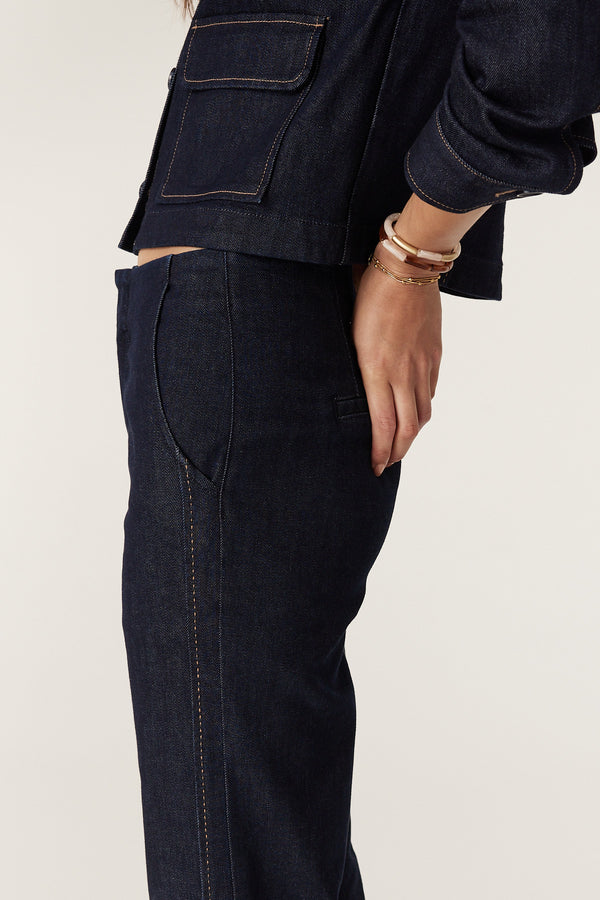 Dark indigo denim Burke Jean with subtle flared leg, pick stitching, and matching jacket.