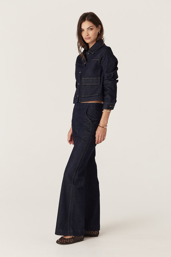 Woman wearing dark indigo Burke Jean with subtle flare and matching denim jacket.