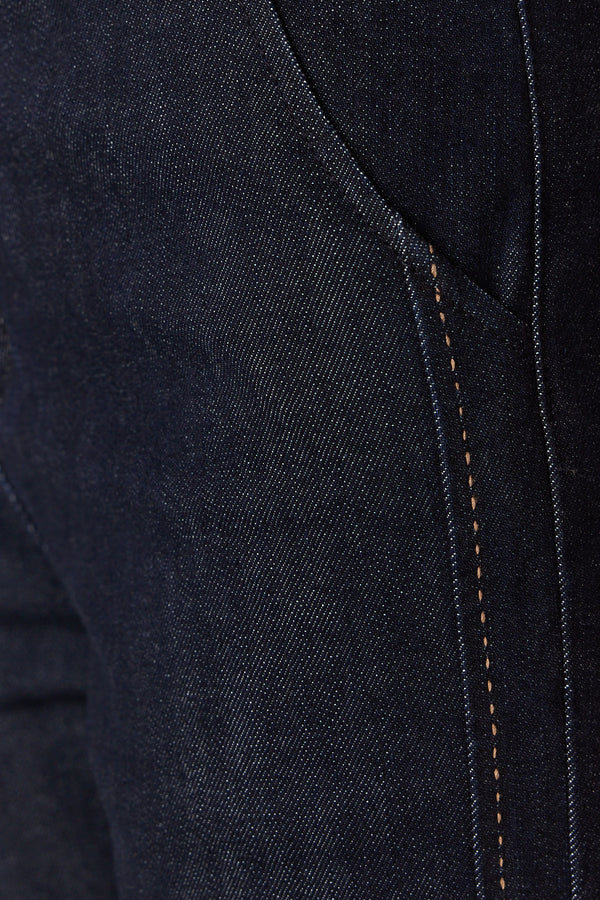 Close-up of dark indigo Burke Jean denim with contrast pick stitching and front pocket detail.