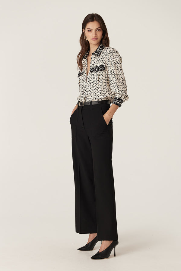 Hamilton Blouse: Ivory geo print silk blend blouse with patch pockets, paired with black pants and heels.
