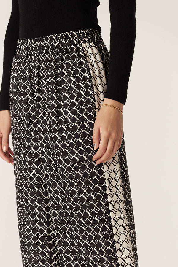 Black geo print silk blend Hamilton Pant with wide leg, elasticated waist, and contrast side panel.