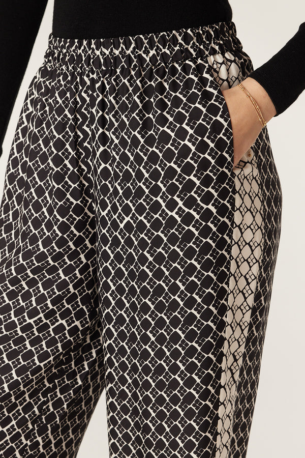 Black Geo Print Hamilton Pant with elasticated waist, side pockets, and contrast print panel.