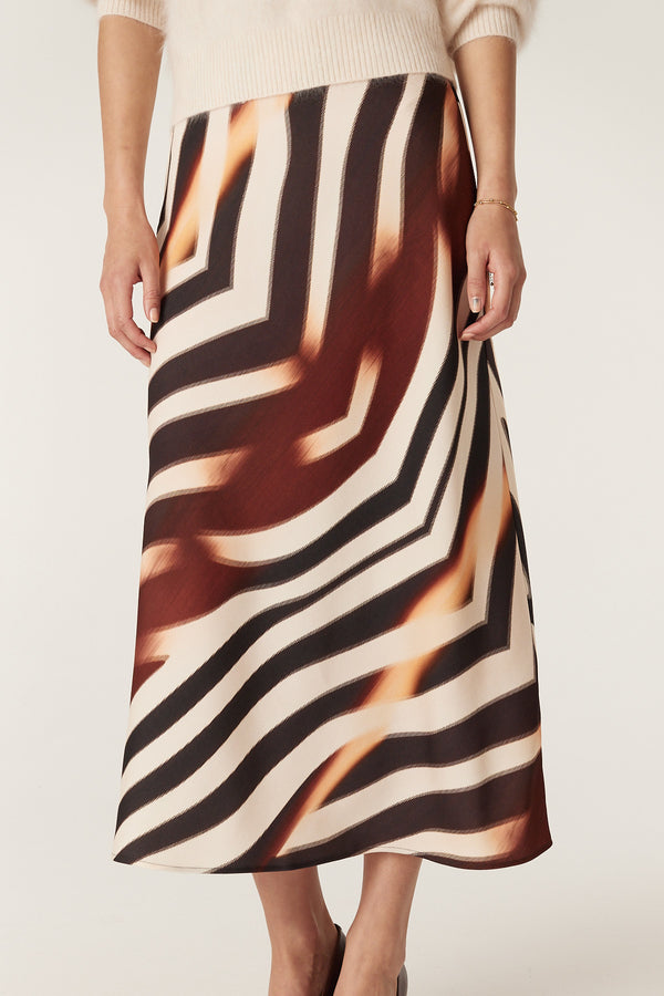 Sasha Zebra Print bias-cut midi skirt with black, brown, and cream stripes, worn with a cream sweater.