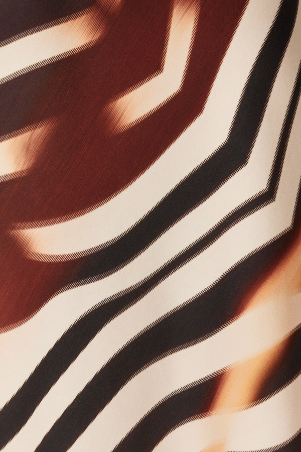Close-up of Sasha Skirt's exclusive zebra print fabric with brown, black, and cream stripes.