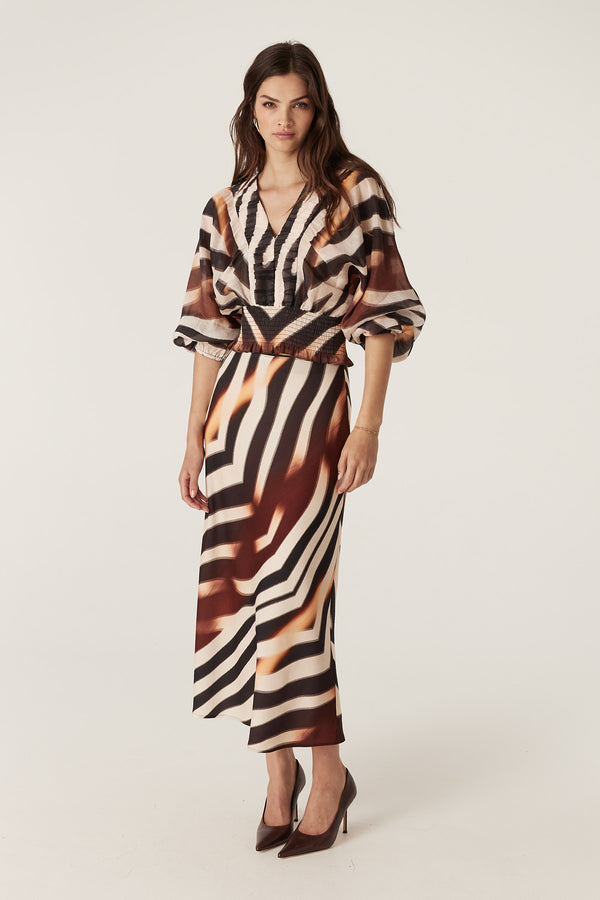 Woman in a brown and white zebra print Sasha Skirt and matching top, bias cut, woven fabric.