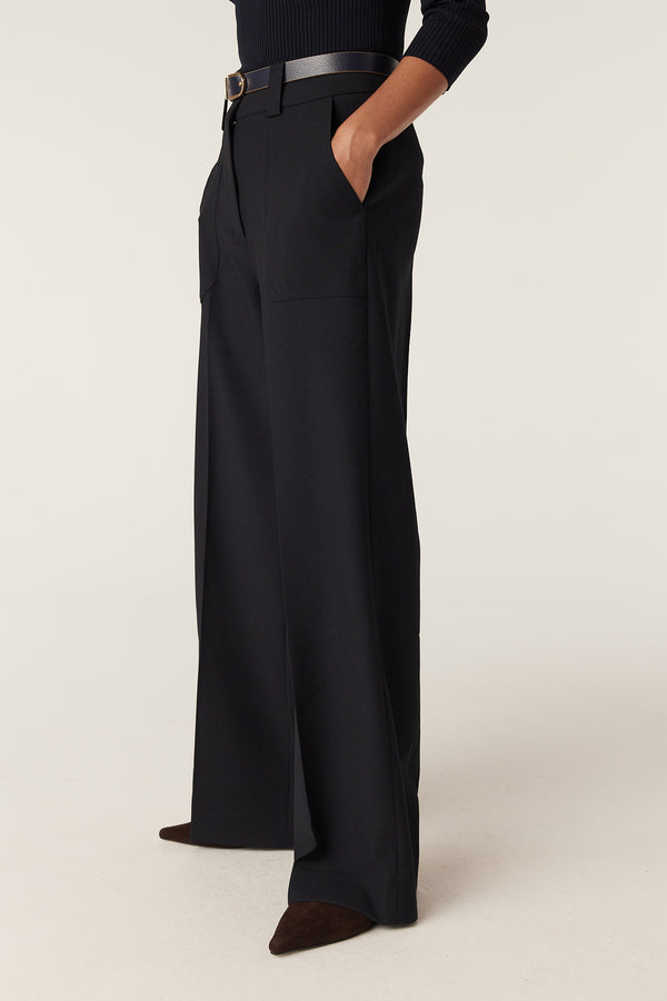Navy Evie wide-leg pants with a high waist, front patch pockets, and a dark belt.