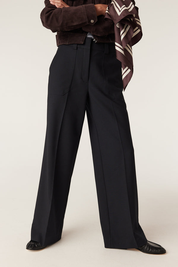 Navy Evie wide leg pants with a high waist, fly front, and front patch pockets.