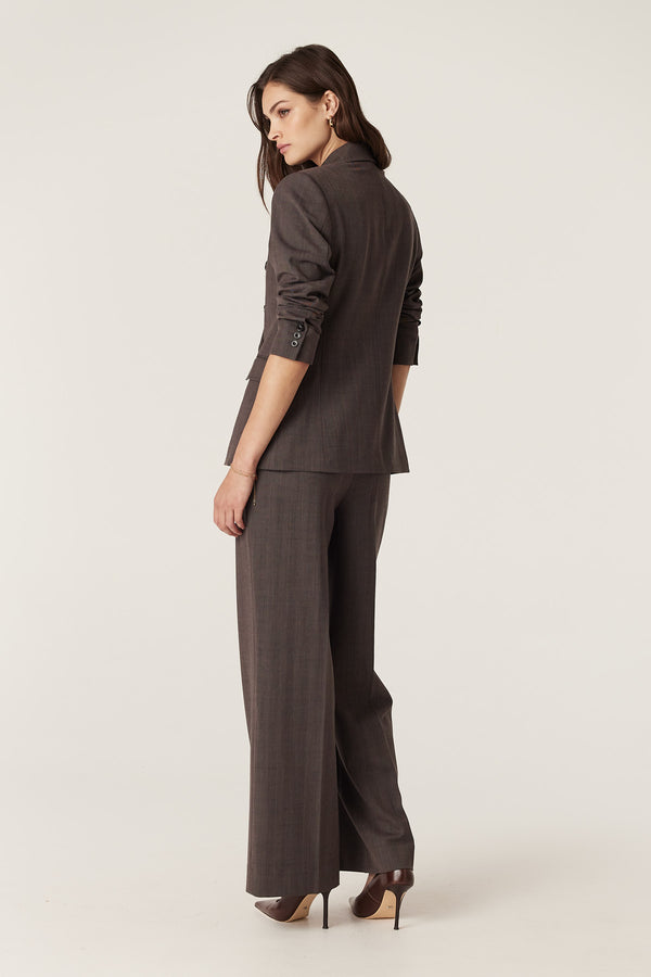 Model in mocha Fletcher wool blend blazer and matching wide-leg pants, viewed from the back.