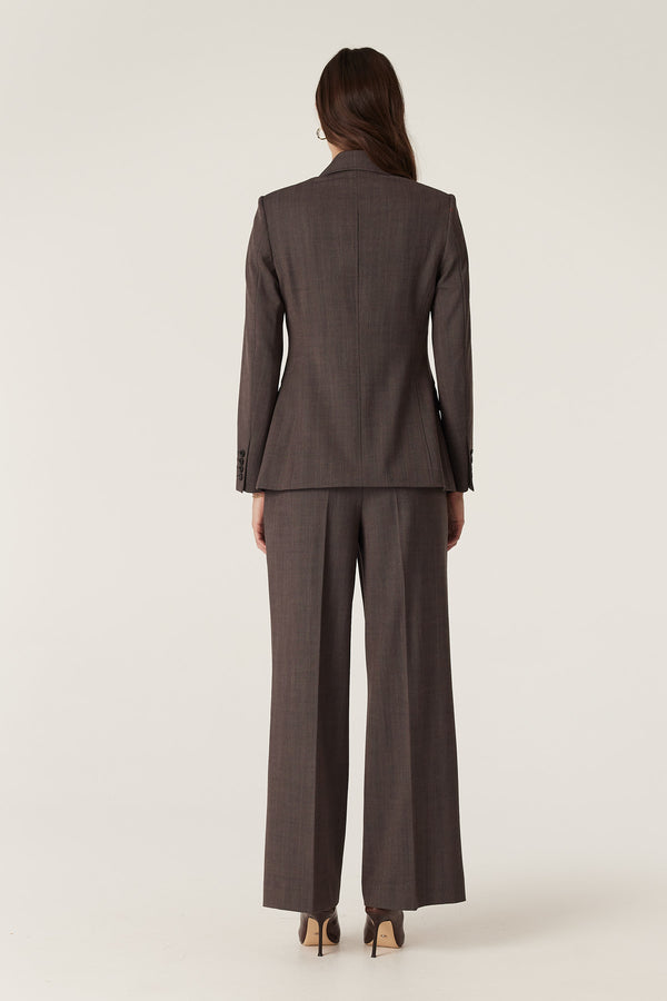 Model from behind wearing a mocha Fletcher wool blazer and wide-leg pants.