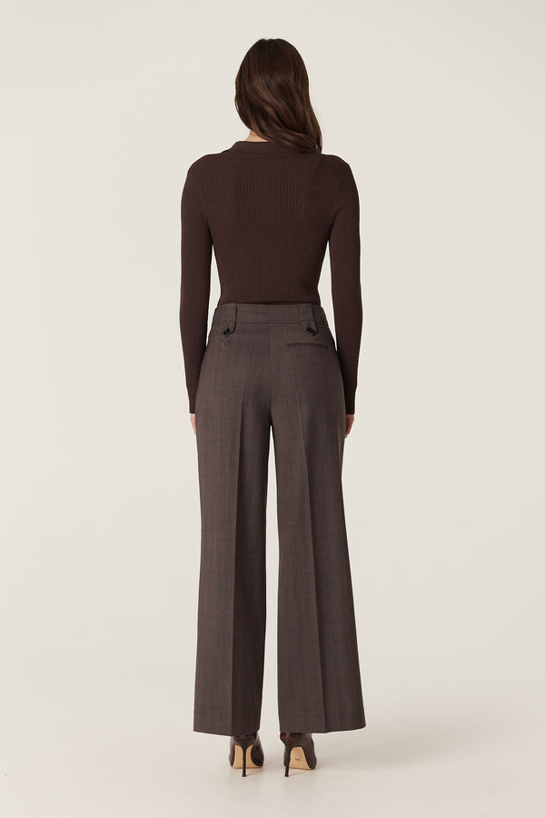 Woman from behind wearing mocha Fletcher wide-leg wool pants with a high waist and tab belt loops.