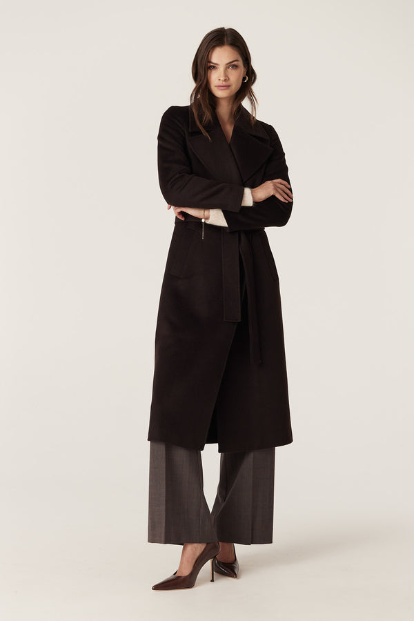 Model in Espresso Evans 100% premium wool tailored wrap coat with fabric belt, front pockets, and pick stitch detail.