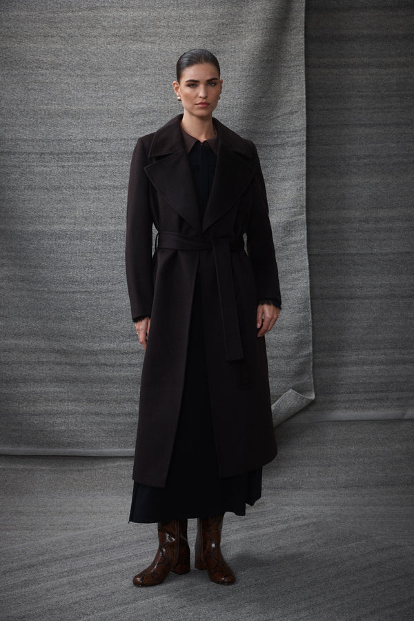Woman in an Espresso Evans tailored wool coat with a wrap closure and fabric belt.