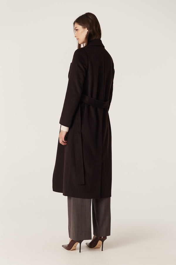 Woman in a tailored espresso Evans wool coat with a wrap closure and fabric belt, viewed from the back.