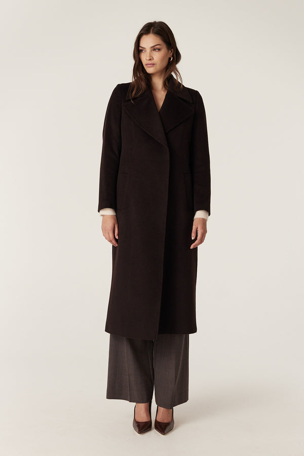 Model wears an Espresso Evans tailored wool wrap coat with matching belt, front pockets, and pick stitch detail.