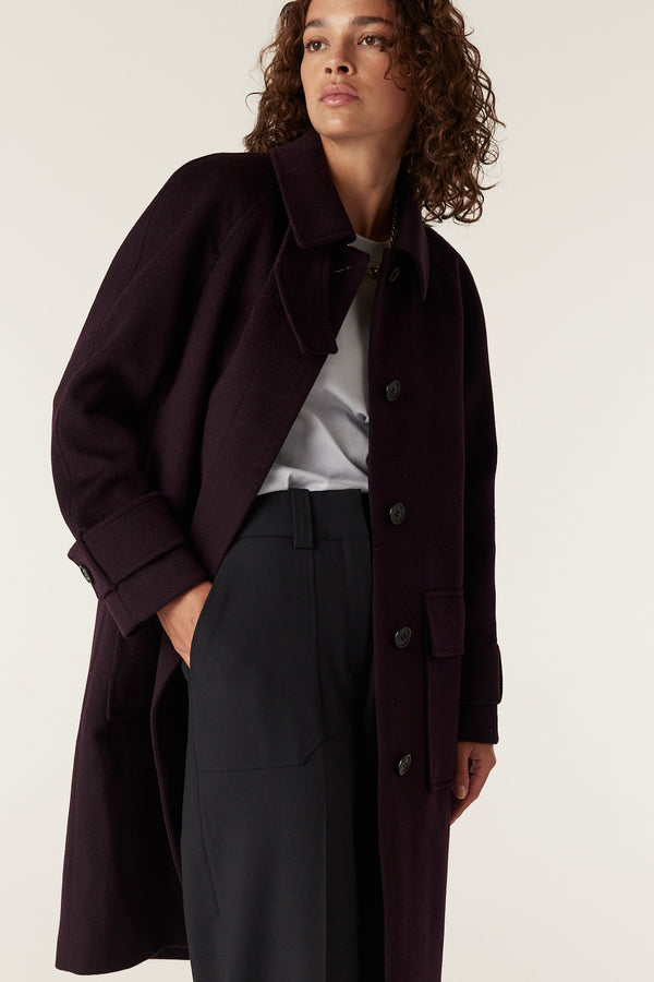 Woman in a relaxed fit Port Oxford wool coat with large buttons and wide cuffs.