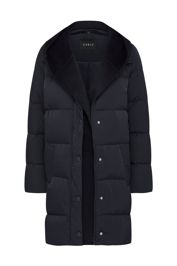 Navy Henderson Puffer jacket with a plush collar, hood, and snap button closure.
