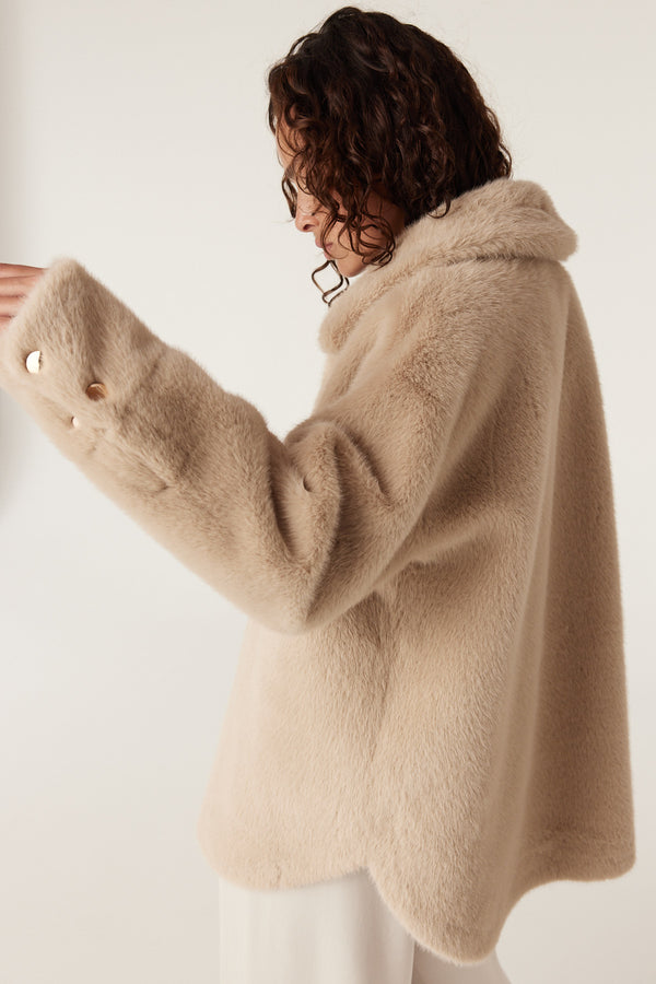 Camel Franzi faux fur jacket with wide collar and gold button cuffs.
