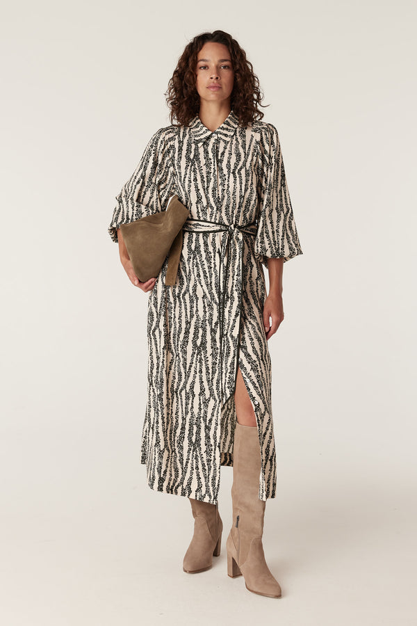Colette midi dress in black and white speckle print, belted, with a collared neckline and side slit.