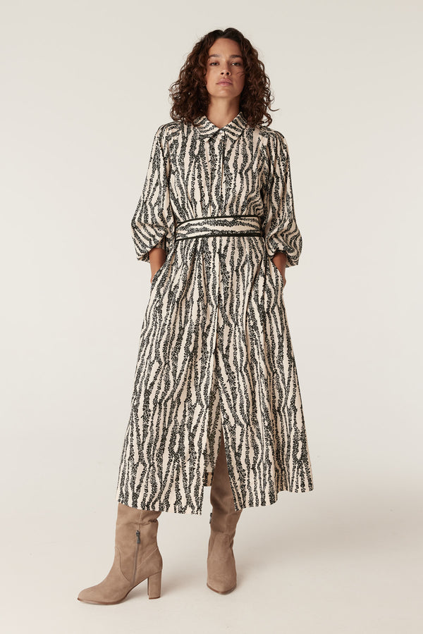 Colette Speckle Print midi dress with collared neckline, belted waist, and long sleeves.
