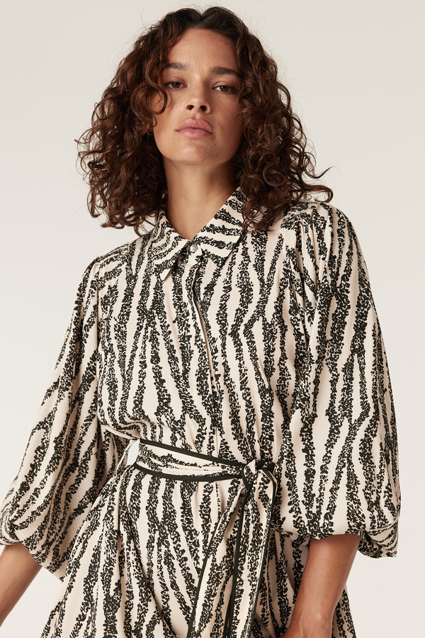 Colette Speckle Print dress: black and white patterned midi with collar, long balloon sleeves, and tie waist.