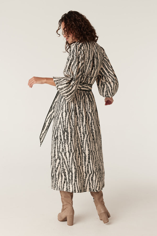 Colette midi dress in black and white speckle print with balloon sleeves and tie waist.